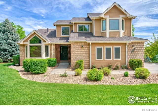5308 Taylor Ln, Fort Collins, CO 80528 - view of front of home with a front lawn, brick siding, and a shingled roof