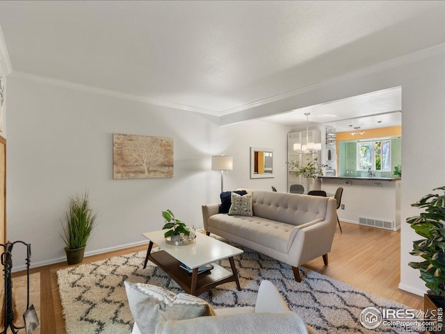3345 Hickok Pl, Boulder, CO 80301 - living room featuring crown molding, a chandelier, wood finished floors, and baseboards