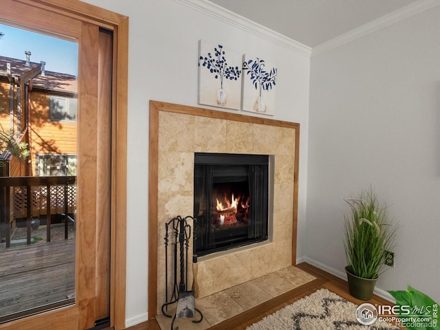 3345 Hickok Pl, Boulder, CO 80301 - detailed view of wood finished floors, crown molding, baseboards, and a tiled fireplace