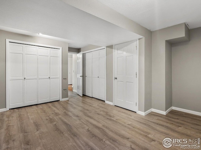 3345 Hickok Pl, Boulder, CO 80301 - unfurnished bedroom with baseboards, wood finished floors, and multiple closets