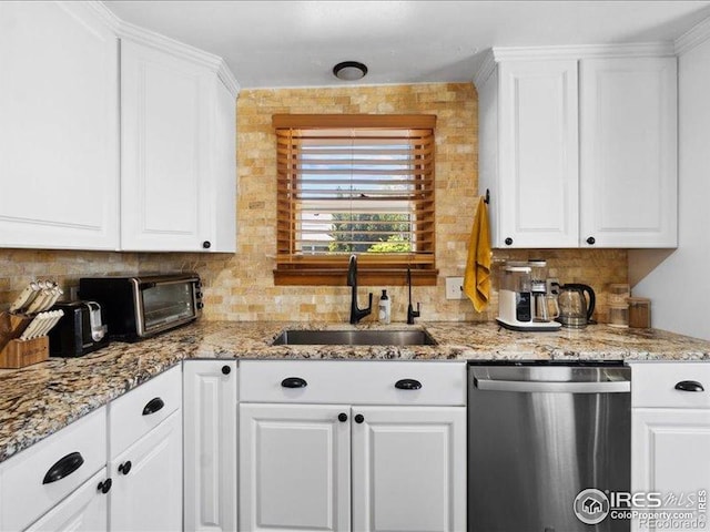 1815 9th Ave, Longmont, CO 80501 - kitchen featuring stainless steel dishwasher, a sink, tasteful backsplash, and white cabinets