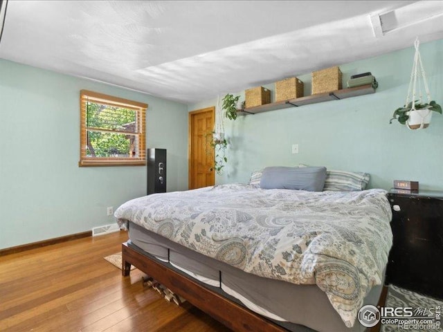 1815 9th Ave, Longmont, CO 80501 - bedroom with wood finished floors, baseboards, and attic access