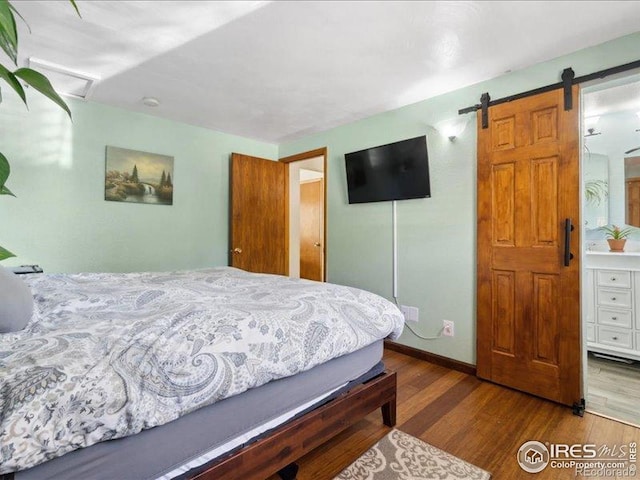 1815 9th Ave, Longmont, CO 80501 - bedroom with wood finished floors and a barn door