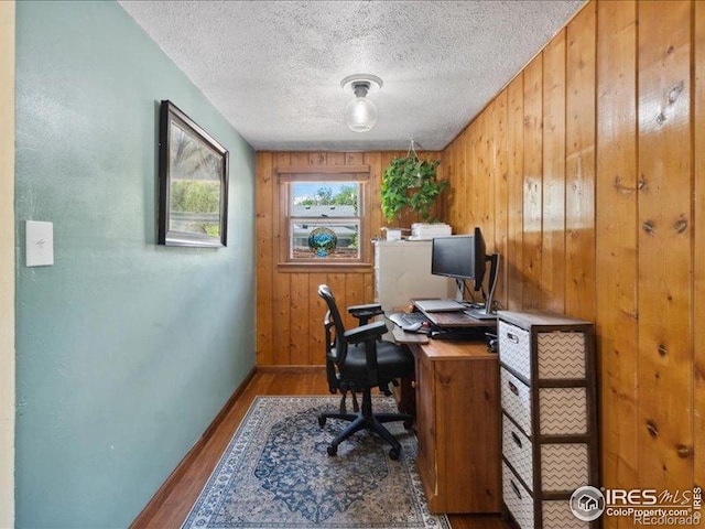 1815 9th Ave, Longmont, CO 80501 - office area with wood walls, wood finished floors, baseboards, and a textured ceiling