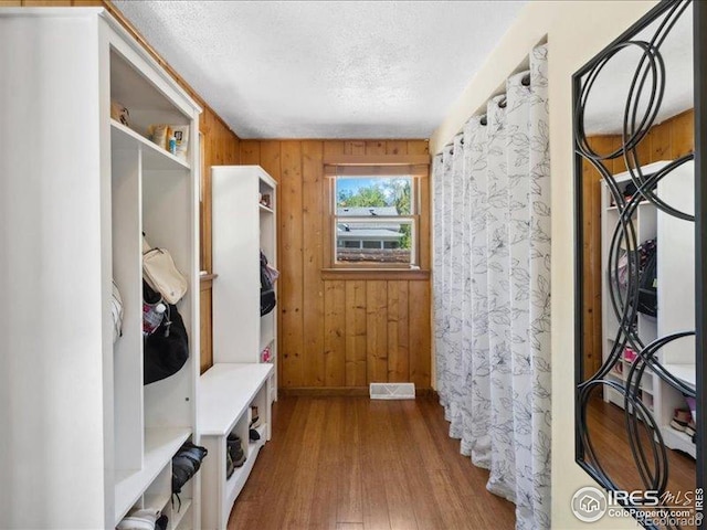 1815 9th Ave, Longmont, CO 80501 - mudroom featuring a textured ceiling, wood finished floors, and wood walls
