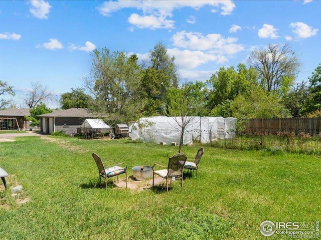 1815 9th Ave, Longmont, CO 80501 - view of yard featuring an outdoor fire pit and an attached garage