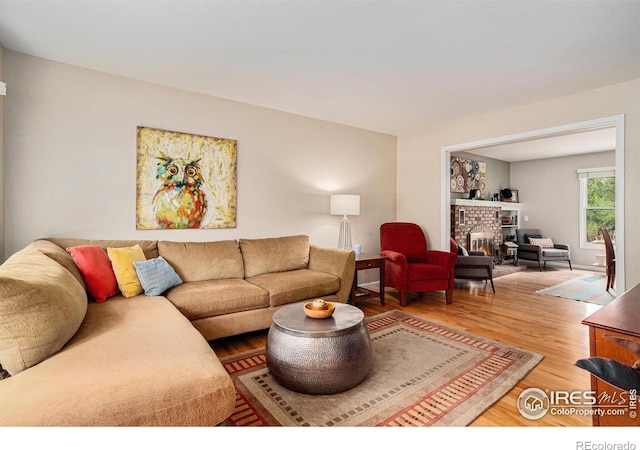 1119 Oakmont Ct, Fort Collins, CO 80525 - living area featuring light wood finished floors and a brick fireplace