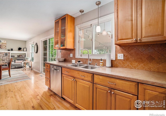1119 Oakmont Ct, Fort Collins, CO 80525 - kitchen with a sink, stainless steel dishwasher, light wood-style flooring, backsplash, and glass insert cabinets