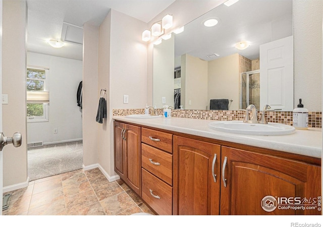 1119 Oakmont Ct, Fort Collins, CO 80525 - full bathroom with a stall shower, decorative backsplash, double vanity, baseboards, and a spacious closet