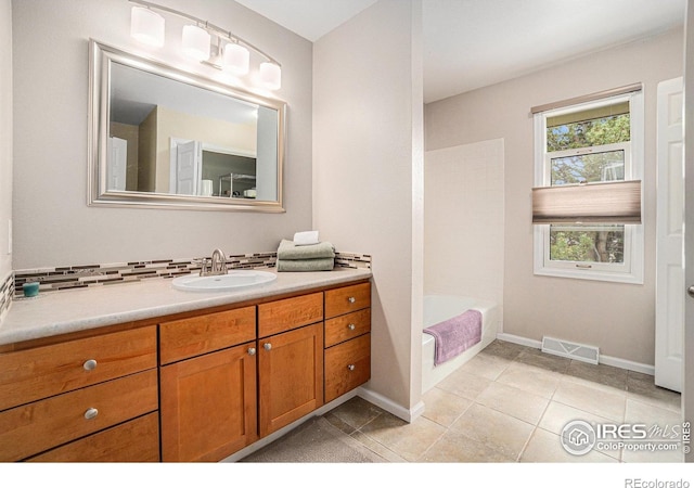 1119 Oakmont Ct, Fort Collins, CO 80525 - full bath featuring vanity, tile patterned floors, baseboards, and backsplash