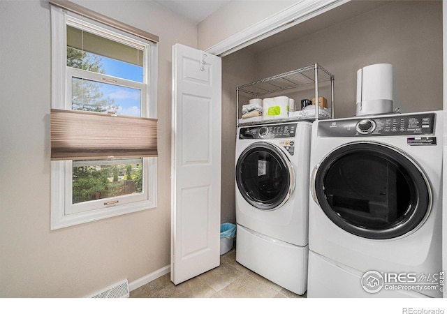 1119 Oakmont Ct, Fort Collins, CO 80525 - laundry area with washing machine and clothes dryer, baseboards, and light tile patterned floors