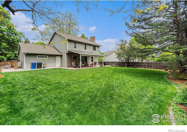 1119 Oakmont Ct, Fort Collins, CO 80525 - back of house featuring a chimney, a patio area, and roof with shingles