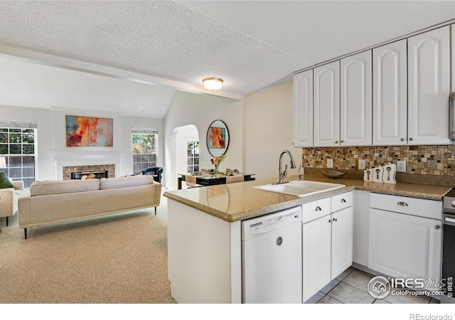 911 Homer Cir, Lafayette, CO 80026 - kitchen with a sink, white dishwasher, arched walkways, a peninsula, and white cabinetry