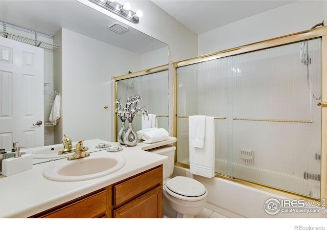 911 Homer Cir, Lafayette, CO 80026 - bathroom with toilet, vanity, bath / shower combo with glass door, and tile patterned flooring