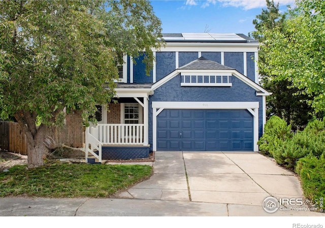 911 Homer Cir, Lafayette, CO 80026 - view of front of property with solar panels, covered porch, concrete driveway, a garage, and stucco siding