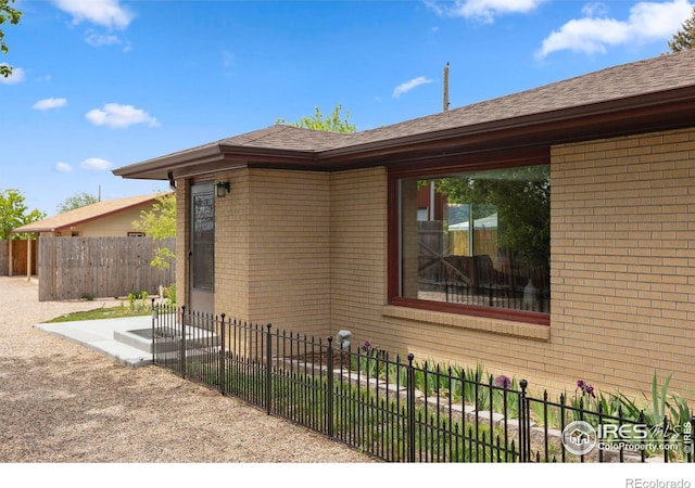 1217 N US Highway 287, Fort Collins, CO 80524 - view of side of home with brick siding and roof with shingles