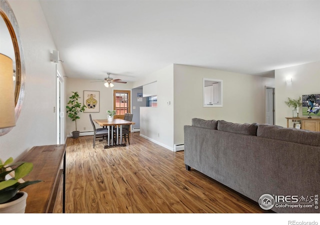 1217 N US Highway 287, Fort Collins, CO 80524 - living room featuring wood finished floors, a baseboard heating unit, a ceiling fan, and baseboards