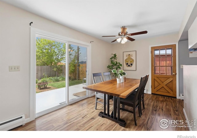 1217 N US Highway 287, Fort Collins, CO 80524 - dining area with a baseboard heating unit, ceiling fan, wood finished floors, and baseboards