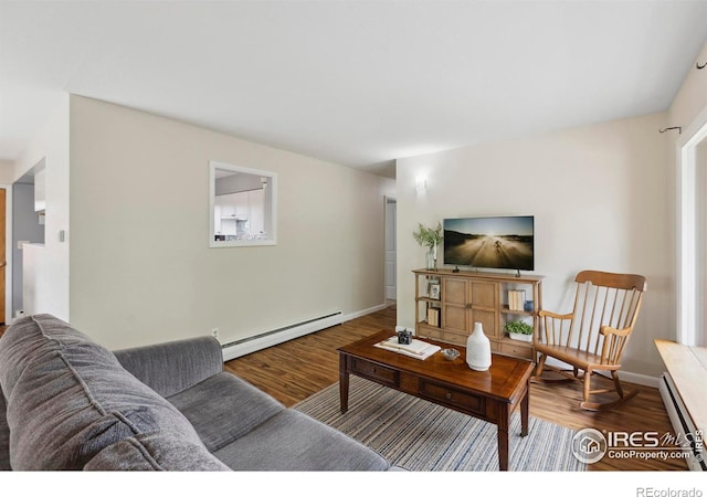 1217 N US Highway 287, Fort Collins, CO 80524 - living area with a baseboard radiator, wood finished floors, and baseboards
