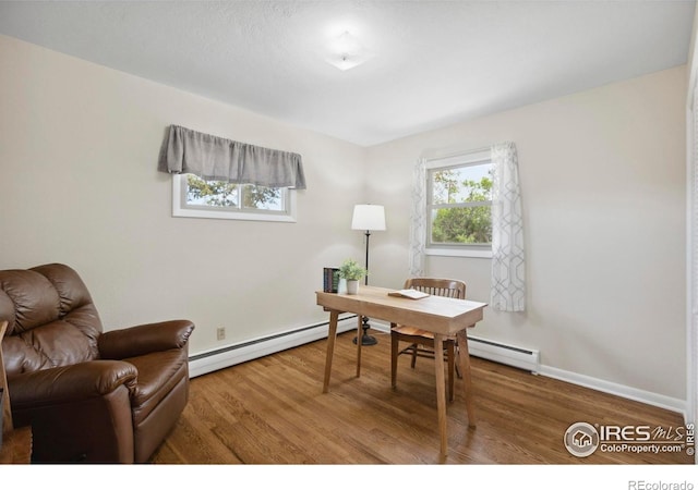 1217 N US Highway 287, Fort Collins, CO 80524 - office space featuring a baseboard heating unit, wood finished floors, and baseboards