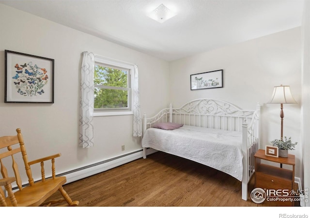 1217 N US Highway 287, Fort Collins, CO 80524 - bedroom with wood finished floors and a baseboard heating unit