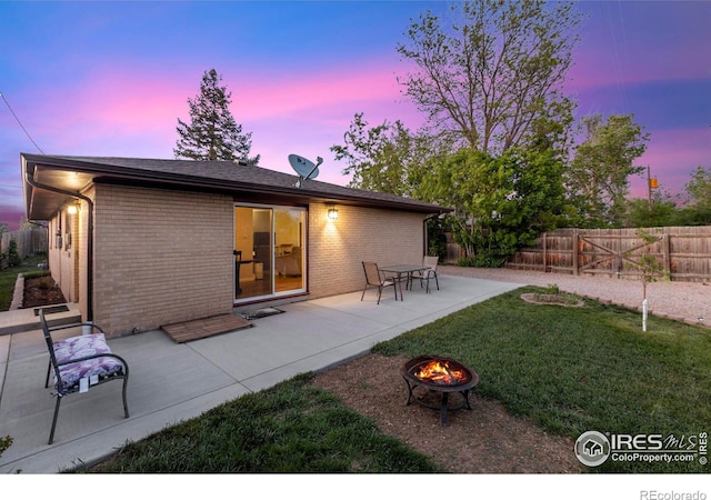 1217 N US Highway 287, Fort Collins, CO 80524 - back of house at dusk with a patio area, brick siding, and an outdoor fire pit