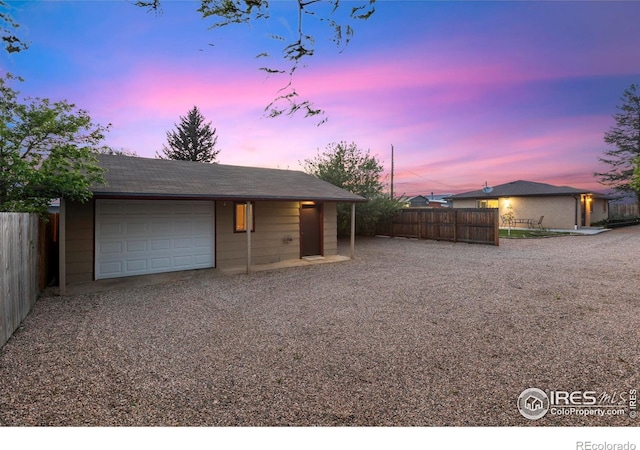 1217 N US Highway 287, Fort Collins, CO 80524 - garage at dusk with a garage and driveway