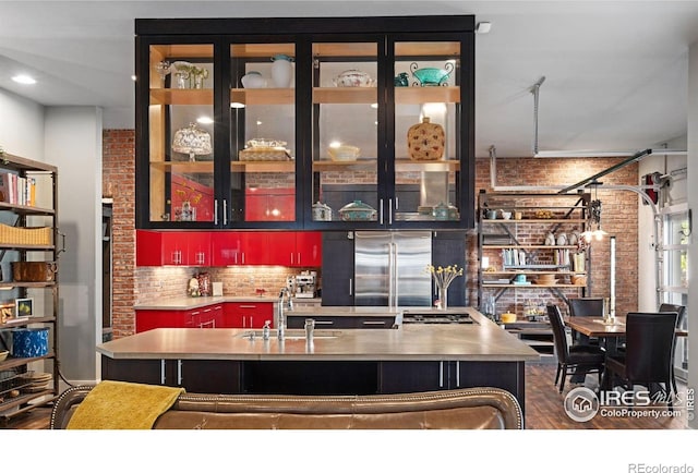 317 Wood St, Fort Collins, CO 80521 - bar with a sink, appliances with stainless steel finishes, brick wall, dark wood finished floors, and tasteful backsplash
