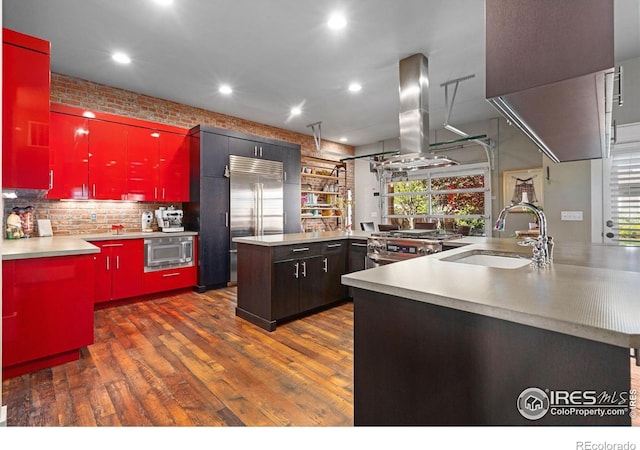 317 Wood St, Fort Collins, CO 80521 - kitchen featuring red cabinets, island range hood, built in appliances, a sink, and recessed lighting