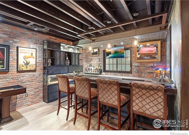 317 Wood St, Fort Collins, CO 80521 - indoor wet bar featuring brick wall, light wood-type flooring, and hanging light fixtures