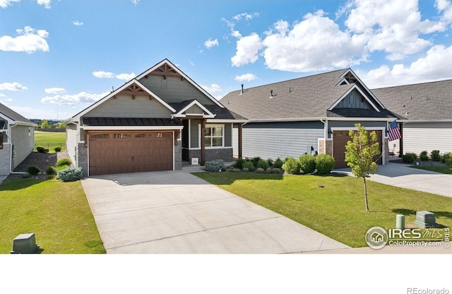 1948 Tidewater Ln, Windsor, CO 80550 - craftsman house featuring concrete driveway, a front yard, and an attached garage