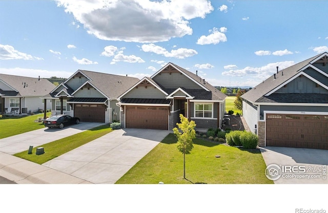 1948 Tidewater Ln, Windsor, CO 80550 - craftsman-style home with a front yard, concrete driveway, and stone siding