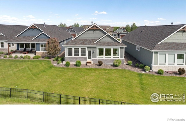 1948 Tidewater Ln, Windsor, CO 80550 - view of front facade featuring stone siding and a patio area