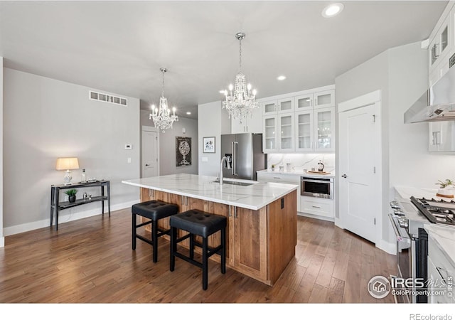 1948 Tidewater Ln, Windsor, CO 80550 - kitchen featuring high end appliances, a chandelier, a sink, an island with sink, and recessed lighting