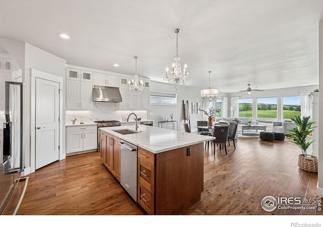1948 Tidewater Ln, Windsor, CO 80550 - kitchen featuring a sink, under cabinet range hood, a chandelier, stainless steel appliances, and hardwood / wood-style flooring