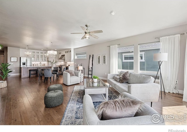 1948 Tidewater Ln, Windsor, CO 80550 - living room with a chandelier, baseboards, dark wood-style floors, and a ceiling fan