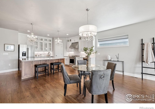 1948 Tidewater Ln, Windsor, CO 80550 - dining room featuring a chandelier, dark wood-style flooring, baseboards, and recessed lighting