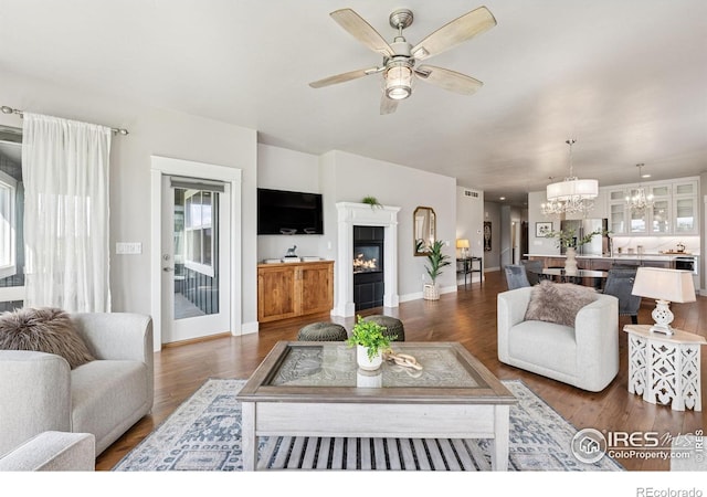 1948 Tidewater Ln, Windsor, CO 80550 - living room with a ceiling fan, a chandelier, baseboards, and wood finished floors