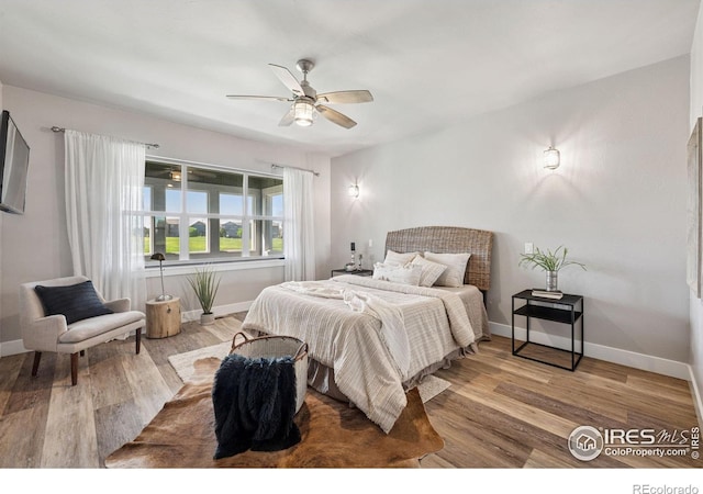 1948 Tidewater Ln, Windsor, CO 80550 - bedroom featuring baseboards, wood finished floors, and ceiling fan
