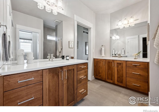 1948 Tidewater Ln, Windsor, CO 80550 - full bathroom featuring two vanities and a tile shower