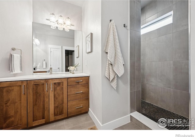 1948 Tidewater Ln, Windsor, CO 80550 - bathroom featuring a walk in shower, vanity, tile patterned floors, and baseboards