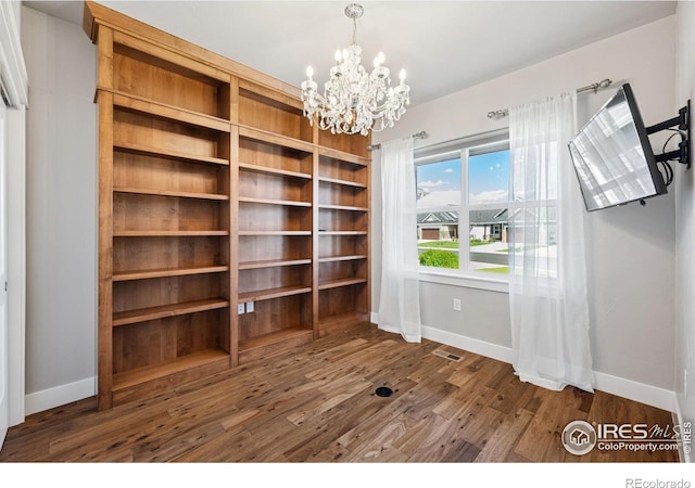 1948 Tidewater Ln, Windsor, CO 80550 - unfurnished dining area with baseboards, a chandelier, and wood finished floors