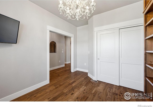 1948 Tidewater Ln, Windsor, CO 80550 - unfurnished bedroom featuring a chandelier, wood finished floors, baseboards, and a closet