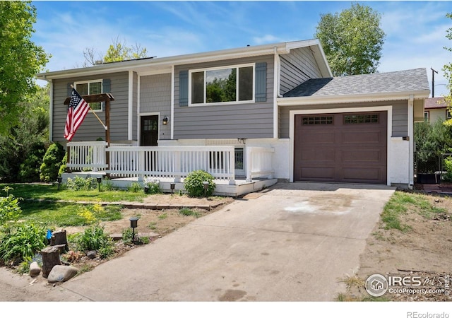 518 Whitmore Ct, Johnstown, CO 80534 - bi-level home featuring a porch, an attached garage, and concrete driveway
