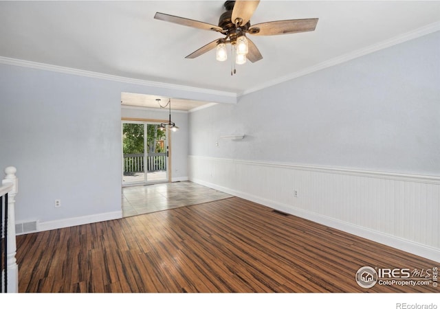 518 Whitmore Ct, Johnstown, CO 80534 - spare room with wood finished floors, ceiling fan, ornamental molding, wainscoting, and baseboards
