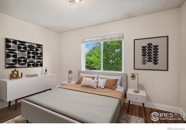 518 Whitmore Ct, Johnstown, CO 80534 - bedroom featuring baseboards, wood finished floors, and a textured ceiling