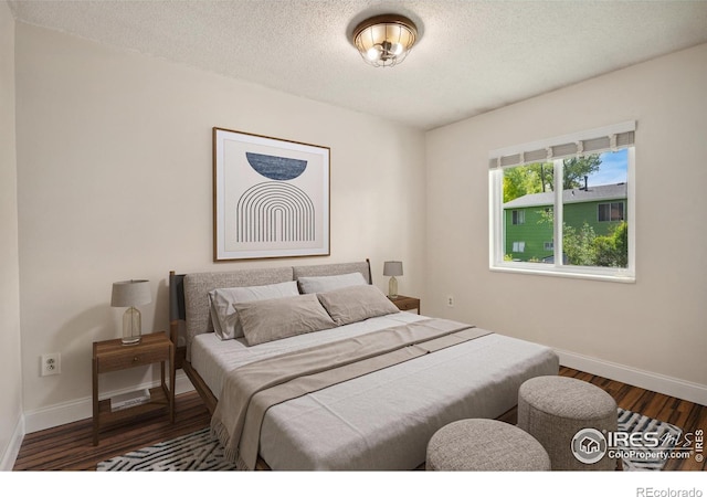518 Whitmore Ct, Johnstown, CO 80534 - bedroom with wood finished floors, baseboards, and a textured ceiling