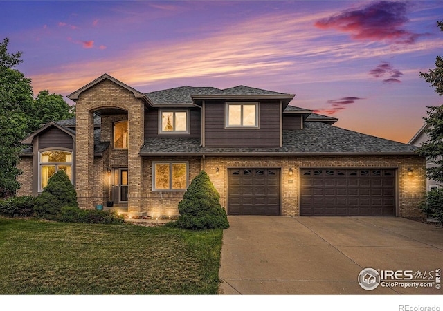 13971 Telluride Dr, Broomfield, CO 80020 - traditional home featuring driveway, brick siding, a front lawn, a shingled roof, and an attached garage