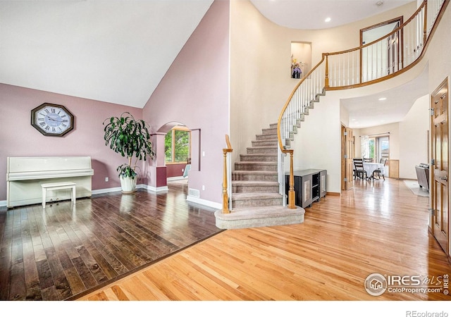 13971 Telluride Dr, Broomfield, CO 80020 - foyer with a high ceiling, stairs, wood-type flooring, plenty of natural light, and arched walkways