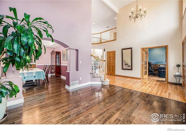 13971 Telluride Dr, Broomfield, CO 80020 - living area with a high ceiling, wood-type flooring, stairs, a chandelier, and an office area